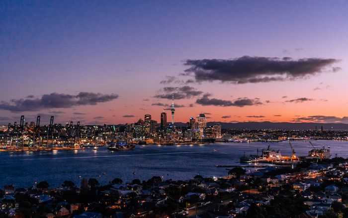 Auckland city skyline across the harbour at twilight