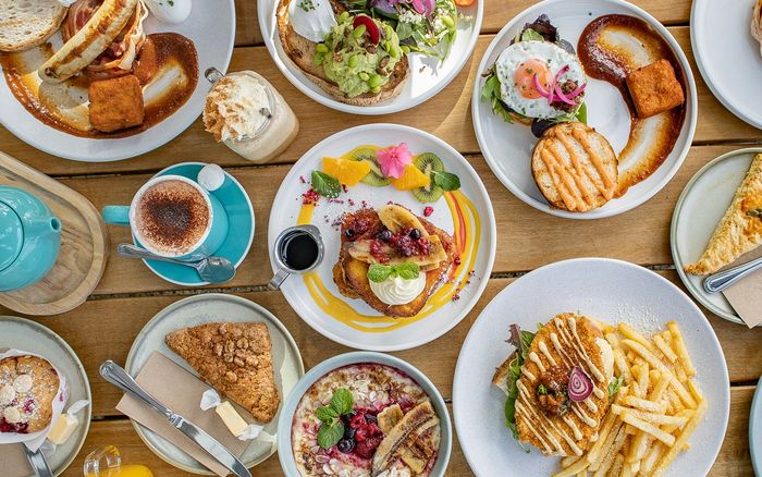 A spread of brunch dishes on a New Zealand cafe table