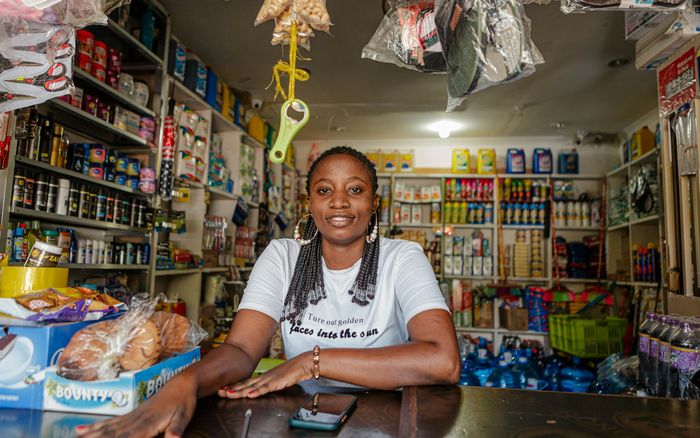 A shop owner sitting at the counter of her store