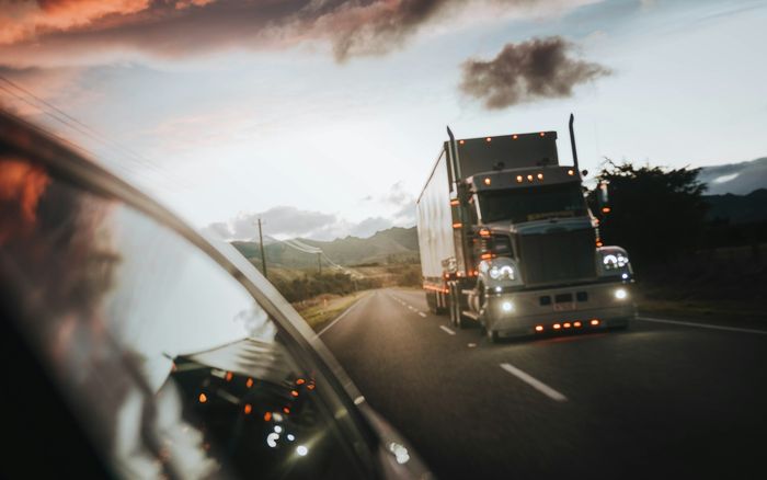 A truck driving along a New Zealand highway in evening light