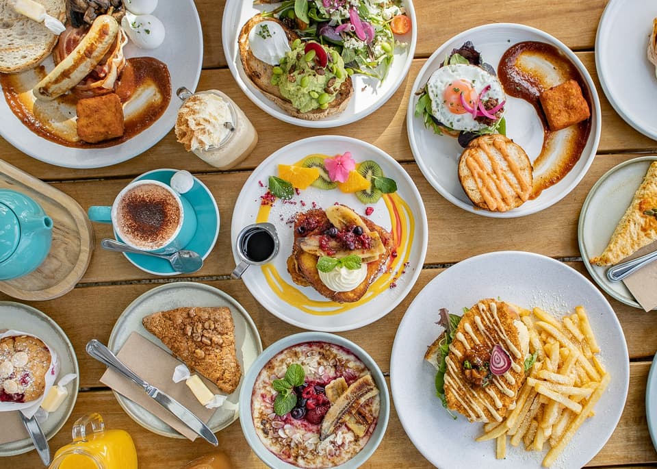 A spread of brunch dishes on a New Zealand cafe table