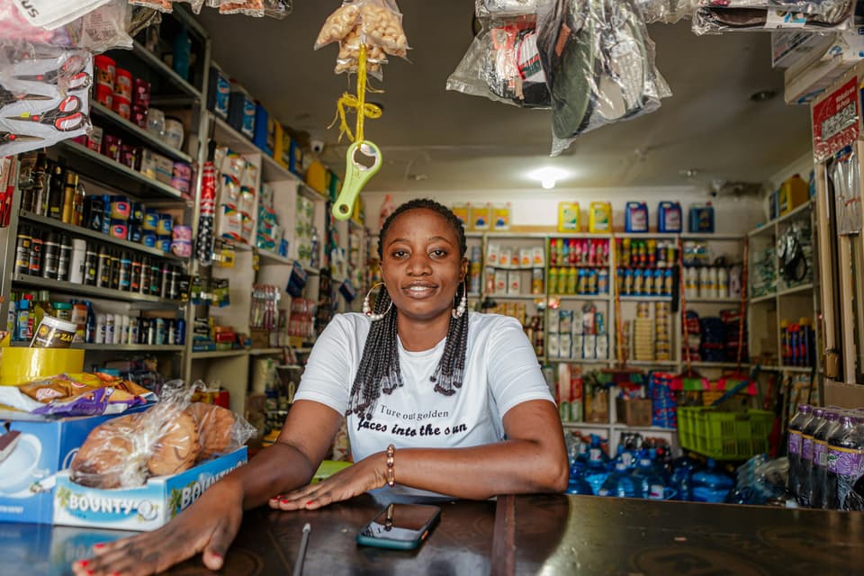 A shop owner sitting at the counter of her store