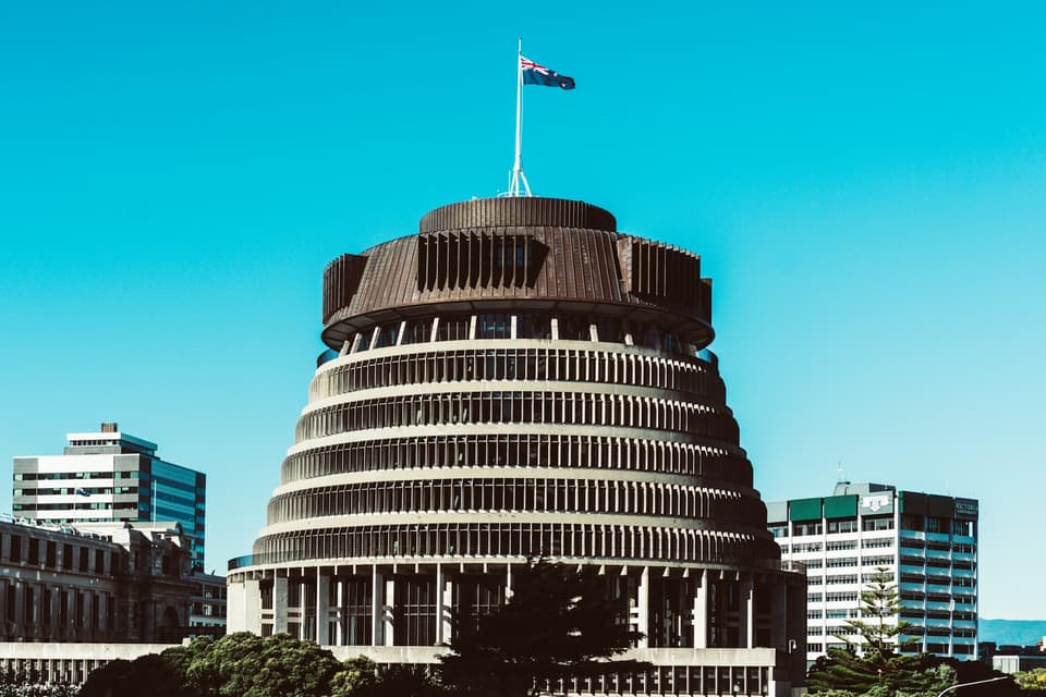 The Beehive parliament building in Wellington under a blue sky